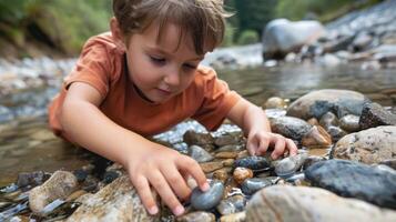 A young child counting and sorting rocks in a creek bed enhancing cognitive skills while exploring nature photo
