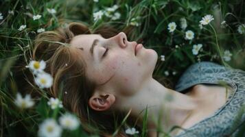 A person lying in a field gazing up at the sky and taking slow intentional breaths photo