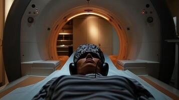 A patient lying inside the MRI machine and wearing ear protection to block out the loud noises of the scan photo