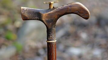 A walking stick with a fourpronged base to prevent slipping or falling photo