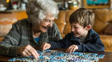 An elderly woman and a young boy sit at a table working on a puzzle together and laughing at their progress photo