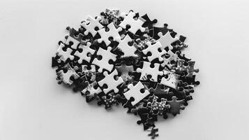 A simplistic black and white poster featuring puzzle pieces forming a brain with the caption Keeping your brain active keeps it healthy photo