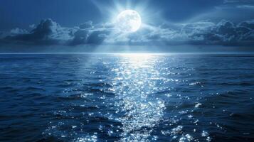The silver rays of the moon dance across the ocean creating a shimmering pathway towards the horizon photo