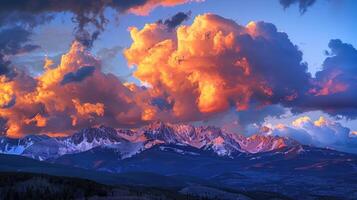 A rare and spectacular occurrence with vibrant vibrant clouds lingering over the mountain range in all its glory photo
