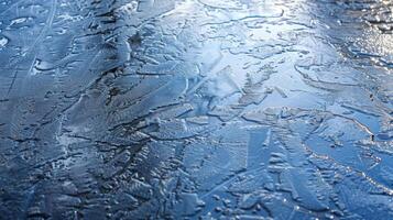 A thin sheet of ice covering the surface of a lake creating a mirrorlike effect photo