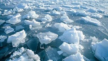 The contrast of white and blue is striking as a frozen lakes calm surface is broken by a jumbled collection of sharp ice shoves moving towards land photo