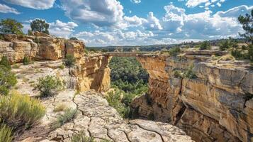 A rugged cliff line is intersected by a naturally formed bridge providing a unique and exciting path for adventurous travelers photo