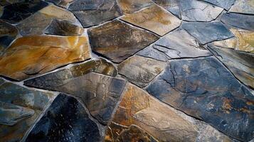 A rough closeup of a natural stone industrial floor showcasing the unique patterns and colors of each individual slab creating a mesmerizing mosaic effect on the ground photo