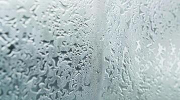 Tiny droplets of moisture create a glaze of dewy condensation on the frosted glass evoking a sense of coolness and tranquility photo