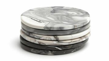 A set of polished ceramic coasters in varying shades of grey each displaying a unique smooth marblelike pattern photo