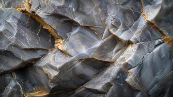 The smooth polished surface reflects light in a mesmerizing display of shimmering shades of grey revealing the hidden beauty in a seemingly ordinary rock photo