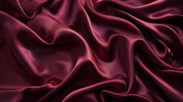 A closeup of a burgundy satin sheet emphasizing the sleek and polished surface of the fabric photo