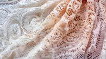A section of crocheted lace showcasing intricate looped and knotted detail and a soft gradient color palette photo