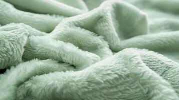 The delicate pastel green fleece showing its fine and velvety surface perfect for cuddling up on a chilly day photo