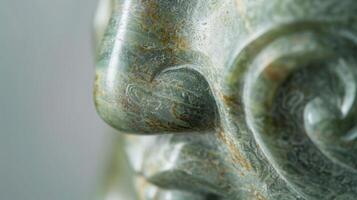 A detailed shot of a smooth jade figurine displaying a tactile matte finish with finely etched details and a marbled green tone photo