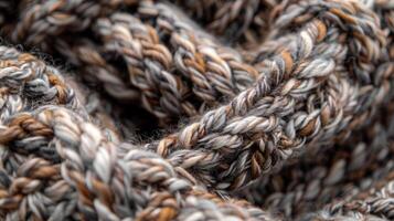 A closeup of the intricate crisscrossing fibers of a chunky handknitted wool scarf highlighting the craftsmanship and thick warmth of the piece photo