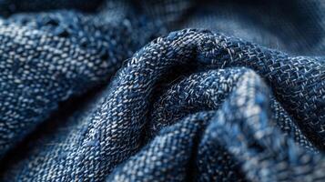 Small intricate loops of thread create a delicate knotted texture intertwined with the sy twill weave of the denim for a rugged yet refined appearance photo