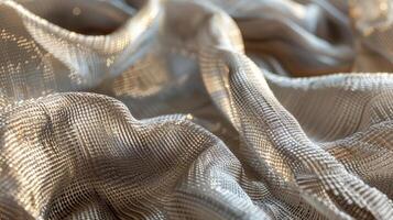 A closeup of a metallic mesh fabric reveals a mix of smooth and rough surfaces adding dimension and interest to the material photo