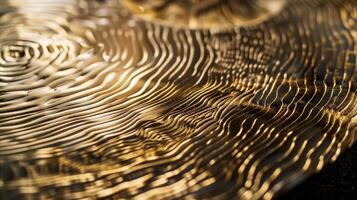 The polished brass is delicately etched with intricate patterns adding depth and texture to its gleaming surface. Faint lines and curves catch the light and create a mesmerizing effect photo