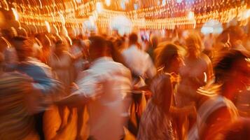 A blurry glimpse of the dance floor packed with guests swaying and moving to the rhythmic music photo