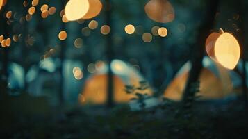 Defocused glimpses of a campsite with indistinct shapes of tents and a subtle firelight shining through photo