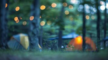 Blurry image of a campsite with soft shapes of tents and a faint firelight peeking through the trees photo