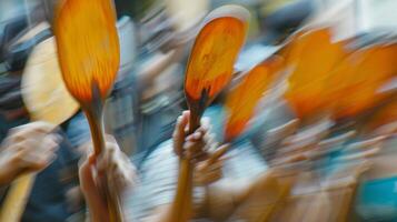 The fuzzy outlines of paddles being raised to signal a bid being made photo