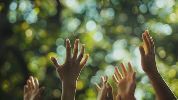 Blurred hands reach up towards the sky moving in unison with the beat of the music photo