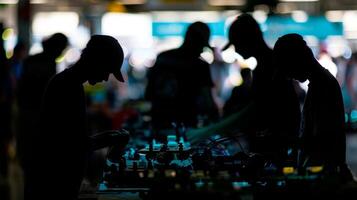 Blurry silhouettes of competitors huddle around their robots making last minute adjustments before the race begins photo