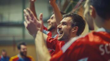Defocused players cheer and celebrate as they score a goal in the indoor game photo