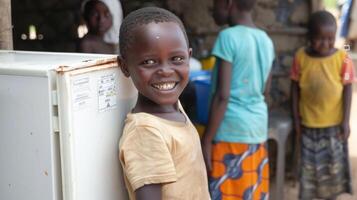 A developing nations community center proudly displaying their new solar powered refrigerator which provides fresh meals and drinks to their local residents photo