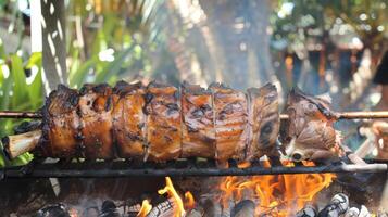 Sweet and savory scents combine as a whole pig roasts on a spit over the fire a popular dish in many tropical cultures photo