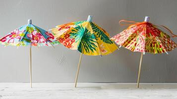 A tropical twist on the classic cocktail umbrella made out of paper and adorned with bright and cheerful patterns photo