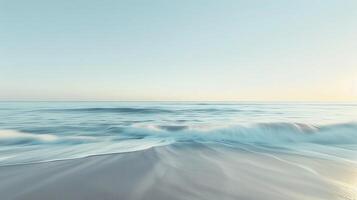 A tranquil beach scene with a blurred horizon the water and sky blending seamlessly together in a wash of muted tones. photo