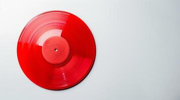 A bold red vinyl record sits against a stark white background standing out and making a bold statement photo