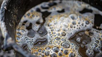 A closeup of a bucket filled with a bubbling and foamy compost tea solution photo