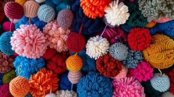 A colorful pompom ornament crafted from repurposed yarn scraps in a variety of sizes and patterns photo
