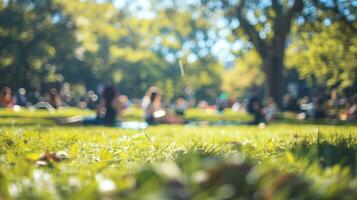 The distant chatter and laughter of a blurred park picnic as people relax and soak up the warm sunny day photo
