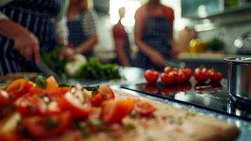 Defocused utensils tered on a kitchen table as the participants practice their chopping skills photo