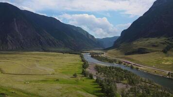 Aerial view of the beautiful valley and river surrounded by high mountain ranges video