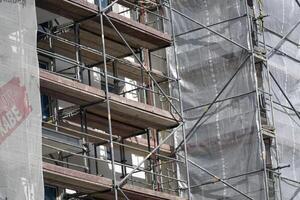 Warsaw, Poland, May 3rd 2024 - Building under construction with scaffolding photo