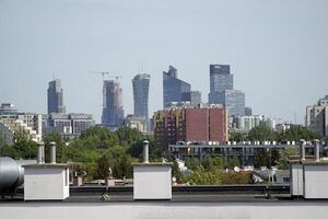 Warsaw, Poland, May 3rd 2024 - Modern residential building and panorama of city center in a distance photo