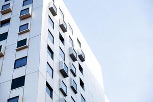 Modern white building with square windows. Multistory apartment building. Minimalistic Stylish living block of flats. Facades of modern office building. Exterior texture pattern. Visual art. Conceptual photo
