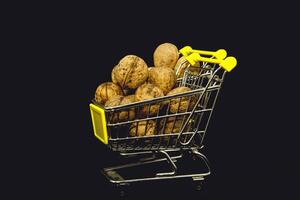 Large walnuts in a basket on a black background photo