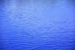 Beautiful background of water on a lake in a park in spring photo