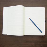 Notebook and pencil on a beautiful background in a large photo studio