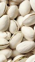 Closeup of pistachio nut seeds pattern texture background, macro pistachios nuts video