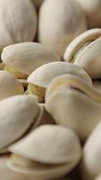 Closeup of pistachio nut seeds pattern texture background, macro pistachios nuts video