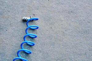 Coiled hose for inflating car wheels with air on asphalt photo