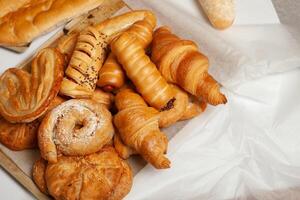 Collection of cakes and different pies with cheese, apple, cherry, meat and cabbage on a plate. Bakery goods. Sweet pastries. photo